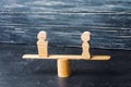 Figures of a man and a woman on the scales. inequality concept : man and women on a weighing balance, gender pay gap. divorce. Div Royalty Free Stock Photo