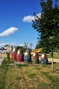 Figures of nesting dolls on the city square. Figures of different heights in a green meadow