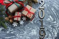 Figures 2019. New year of the pig. Festive Christmas composition with gifts, boxes, cones, walnuts, red flowers poinsettia on a wo Royalty Free Stock Photo