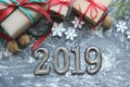 Figures 2019. New year of the pig. Festive Christmas composition with gifts, boxes, cones, walnuts, red flowers poinsettia on a wo Royalty Free Stock Photo