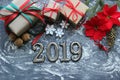 Figures 2019. New year of the pig. Festive Christmas composition with gifts, boxes, cones, walnuts, red flowers poinsettia on a wo Royalty Free Stock Photo