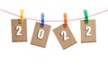 Figures for 2022 are posted on clothespins, on clothesline, on white background Royalty Free Stock Photo