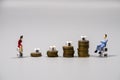 Figures represent different risks with coins in a financial setting Royalty Free Stock Photo