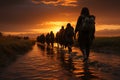 Figures in silhouette, the determined emigrants march resolutely towards destiny Royalty Free Stock Photo