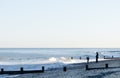 Figures silhouetted on an evening beach in England. Royalty Free Stock Photo