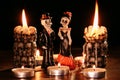 Halloween: figures of two skeletons of the man and the woman against the background of the burning candles in the form