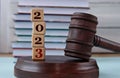 Figures of the year 2023 on wooden cubes against the background of the judge\'s hammer and stand Royalty Free Stock Photo