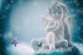 Figurine of an angel in blurred background Royalty Free Stock Photo