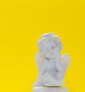 Figurine Of Baby Angel On Yellow Background 1 Royalty Free Stock Photo