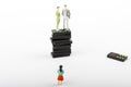 A figurine of a A couple on the top pf domino towerand a child on the bottom Royalty Free Stock Photo