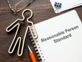 Figurine and document about Reasonable person standard. Royalty Free Stock Photo