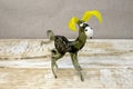 Figurine of donkey made from glass on rough wooden background