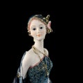 Ceramic figurine of a fantastic woman in a blue dress on a black background. porcelain antique figurine of a woman in retro clothe