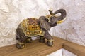 A figurine of an elephant on a shelf luck, happiness in the house