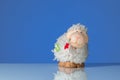 Figurine of a funny white sheep with a red flower Royalty Free Stock Photo