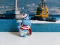 Figurine hippo-a sailor on the background of a sea tug. Close-up. Hobby. Kinderfilia