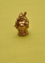 Figurine of a laughing and cheerful golden Buddha Royalty Free Stock Photo