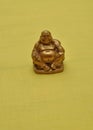 Figurine of a laughing and cheerful golden Buddha Royalty Free Stock Photo