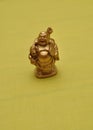 Figurine of a laughing and cheerful golden Buddha Royalty Free Stock Photo