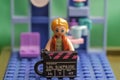 Figurine of a lego girl with a movie player