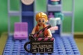 Figurine of a lego girl with a movie player