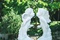 Figurine of kissing cupid boy and fairy girl in summer garden Royalty Free Stock Photo