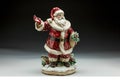 A figurine of Santa Claus holding a red bag filled with gifts is showcased against a white background, A porcelain Santa Claus Royalty Free Stock Photo