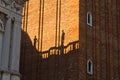 Figurine shadows on a Campanila bell tower wall at piazza San Marco in Venice Royalty Free Stock Photo