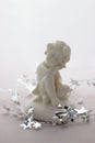 Figurine of a sleeping angel on a white background. Royalty Free Stock Photo