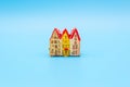 Figurine of small vintage old European houses on a blue background, the concept of your own home and comfort