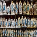 Figurine statues of the Virgin Mary on sale at a tourist souvenir shop in Lourdes, France