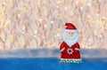 Figurine toy Santa Claus on colorful undulation bokeh background Royalty Free Stock Photo