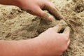 Figure of sand in the shape of a heart with hands of a child Royalty Free Stock Photo