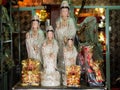 Figurines of the Goddess of Mercy, Guan Yin and the God of Fortune, Cai Shen, at a Taoist prayer items store Royalty Free Stock Photo