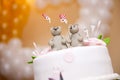 Figurines of two bears with hearts in their hands made of edible materials sit on top of a wedding cake. Figurines of a Royalty Free Stock Photo