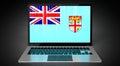 Fiji - country flag and binary code on laptop screen