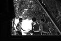 Fijian Children Sitting on Bench Talking Through Window