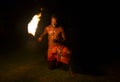 Fijian man holds a tourch during a fire dance