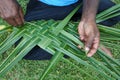 Fijian men create a basket from weaving a Coconut Palm leaves Royalty Free Stock Photo