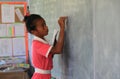 A Fijian student writes on the board.