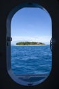 Fijian tropical island view from a boat door porthole, Fiji, Pacific Ocean