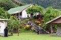 Fijians walking up stairs to church in village