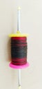 Fikri/chakri/reel/spool/spindle with colourful thread or manja for kite flying. Royalty Free Stock Photo