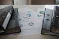 file folder with documents on the desk related to business functions.
