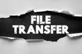 File Transfer words under torn paper background showing digital data exchange, cloud sharing, online upload and download processes Royalty Free Stock Photo