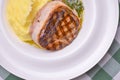 Filet mignon with mashed potatoes and pesto sauce served in a white plate over green plaid tablecloth. Beef steak. Royalty Free Stock Photo