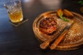 Filet mignon medium rare served on a wooden plate with baked potatoes Royalty Free Stock Photo