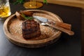 Filet mignon medium rare served on a wooden plate with baked potatoes Royalty Free Stock Photo