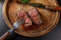 Filet mignon medium rare served on a wooden plate with baked potatoes Royalty Free Stock Photo