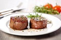 filet mignon on a white plate with sprig of thyme Royalty Free Stock Photo